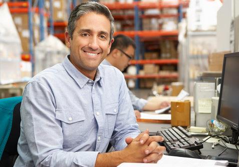 Businessman Working At Desk In Warehouse